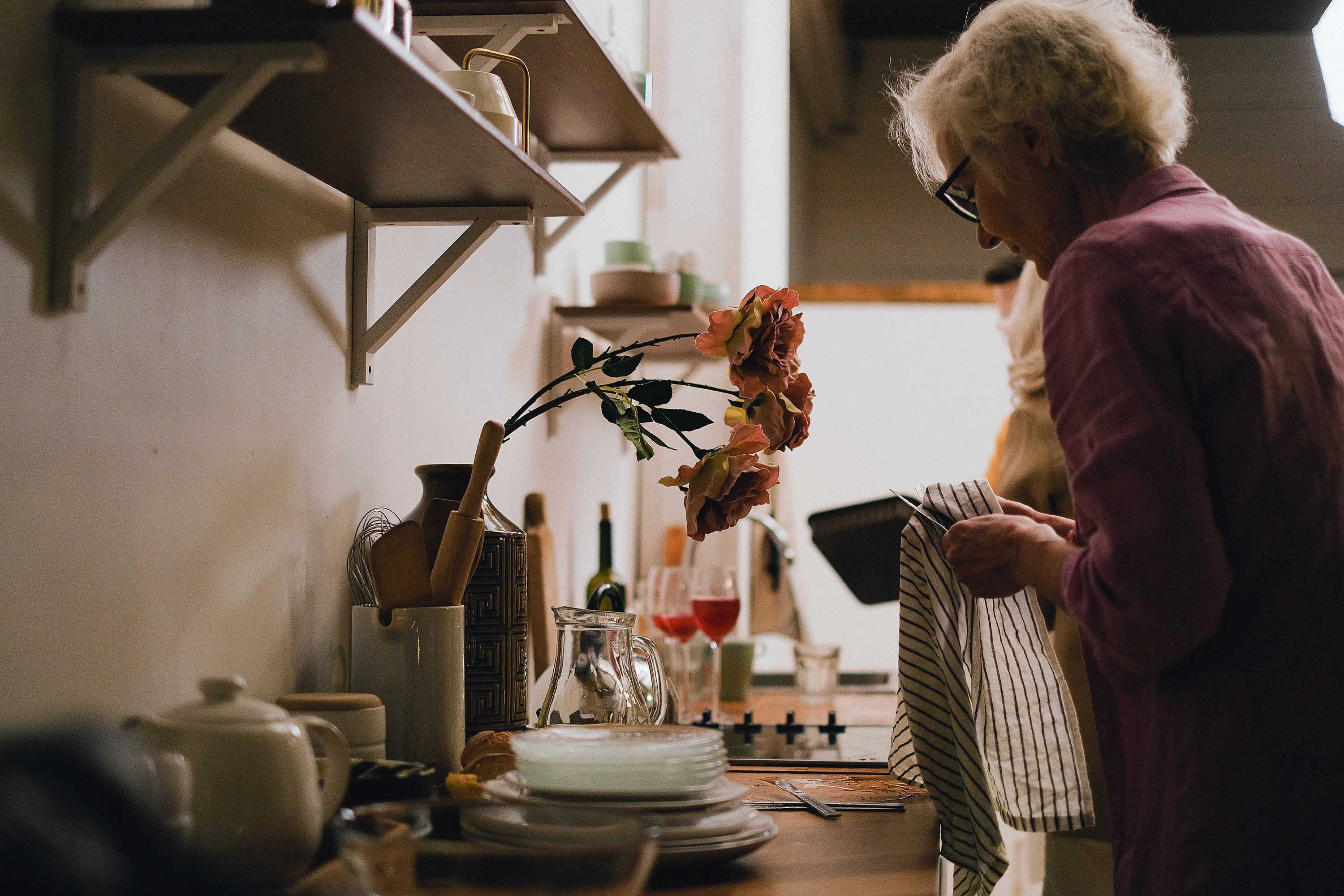 a woman drying dishes